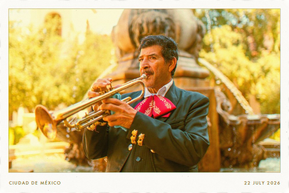 A postcard of a mariachi trumpeter playing beside a fountain.